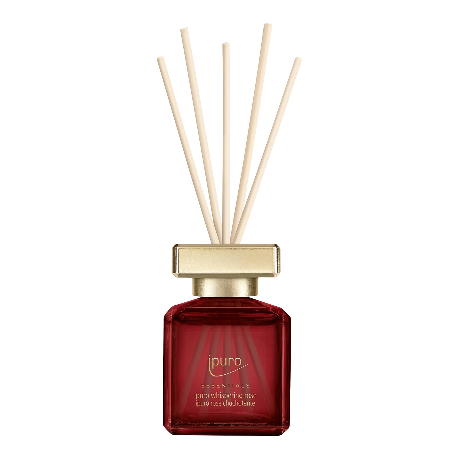 Der ESSENTIALS ipuro whispering rose Raumduft von ipuro aus rotem Glas mit goldener Kappe und hellen Stäbchen verbreitet fruchtige Noten und holzige Aromen für einen erfrischenden Duft.