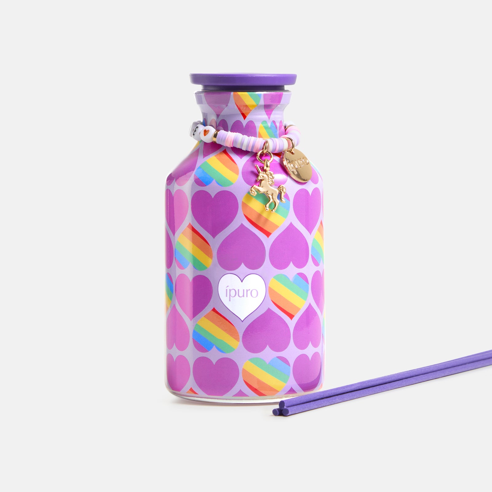 Die LIMITED EDITION ipuro vibrant love Raumduft 240ml besteht aus einer farbenfrohen Flasche mit lilafarbenem Deckel, Regenbogenstreifen und lilafarbenen Herzen, zwei lilafarbenen Schilfrohren, einem Perlenarmband und fruchtigen Düften. Das ipuro-Logo befindet sich auf der Vorderseite.